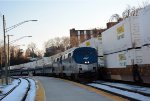 J.B. Hunt containers pass by Amtrak #20(21)